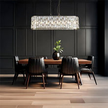Load image into Gallery viewer, Dining room with wooden table and chairs under a rectangular crystal chandelier against a dark panelled wall, Bijou 8 Light Oval Diner Pendant Antique Brass Metal &amp; Champagne, LHSL65818-8AB, ceiling light,
