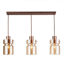 Load image into Gallery viewer, Three-light linear pendant ceiling fixture with a warm bronze rectangular canopy, three hanging cords, and clear glass shades with metallic rose-gold-toned tops and visible Edison bulbs, shown on a white background.
