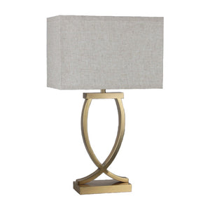 A rectangular fabric table lamp shade in beige color, with an antique brass base and a 3-pin plug.