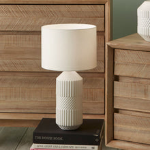 Load image into Gallery viewer, This beautiful tall ceramic table lamp features a textured tactile detail. Finished in a simple white glaze this lamp also comes complete with a matching white shade to finish the clean neutral look.
